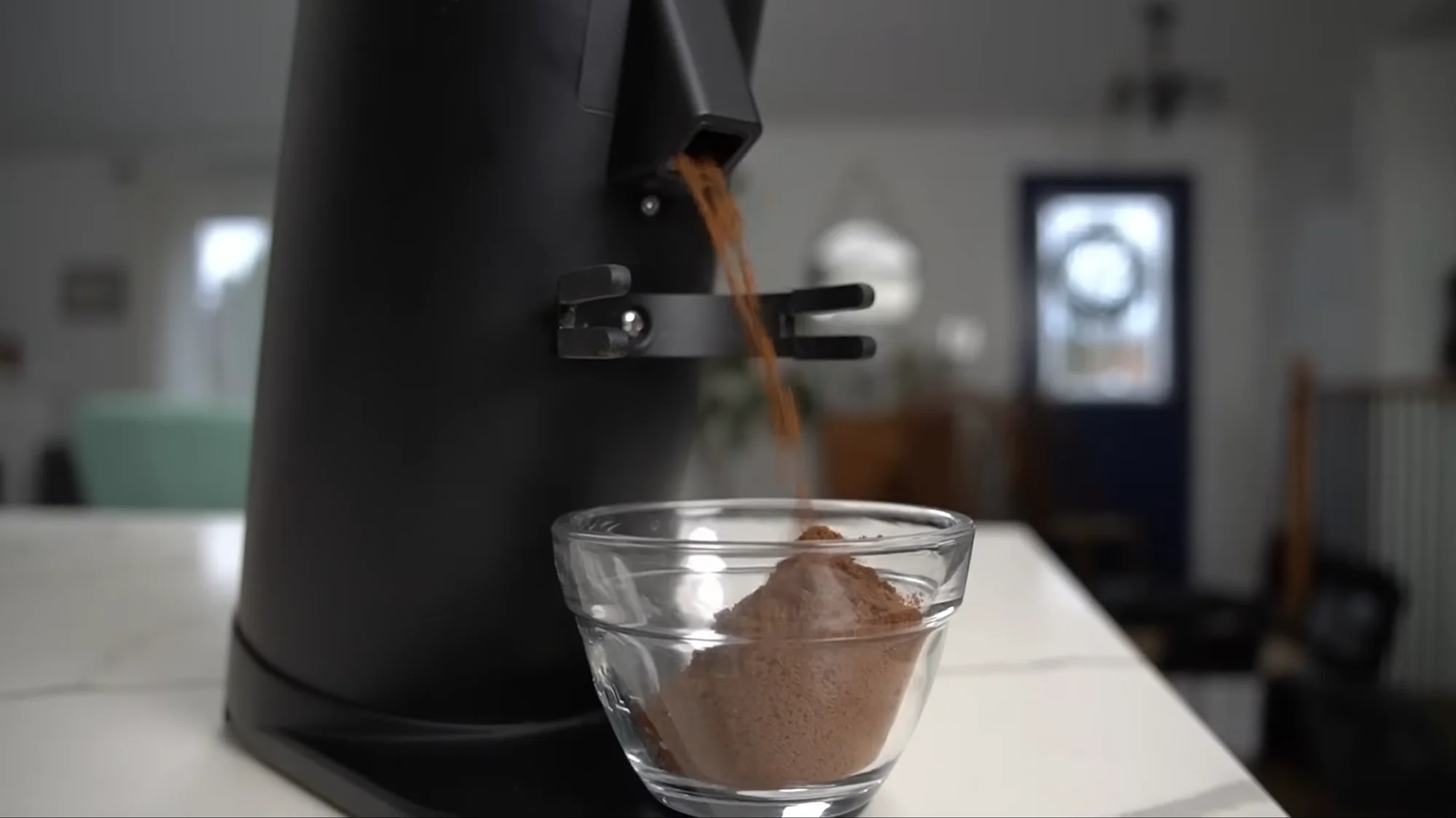 Turin DF64 Gen 2.5 grinding coffee into glass bowl