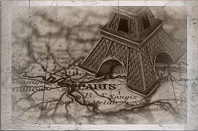 scratched photo of eiffel tower on map with paris